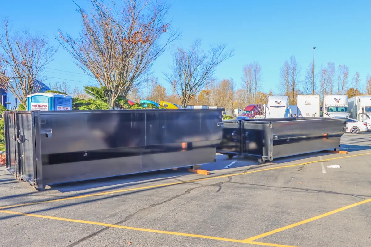 Professional dumpster rental service with roll-off container on residential driveway in Millsboro